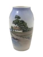 ROYAL COPENHAGEN
Vase en porcelaine à décor d'un paysage maritime, signé
H.:...