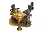 GROUPE en bronze représentant trois personnages autour d'une table
H.: 7.5...