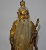 ASIE
Vieillard en bois sculpté et doré représenté debout tenant son...