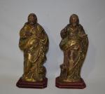 Deux SUJETS en bois sculpté, peint et doré représentant deux...